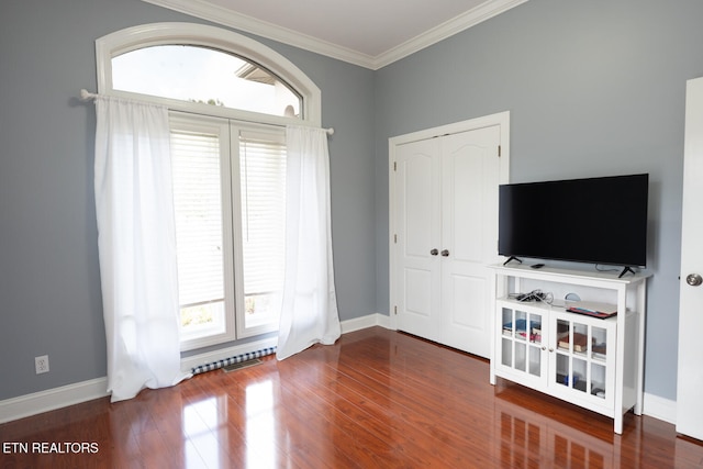 unfurnished living room featuring ornamental molding and wood-type flooring