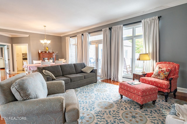 living room featuring crown molding, a chandelier, and wood-type flooring