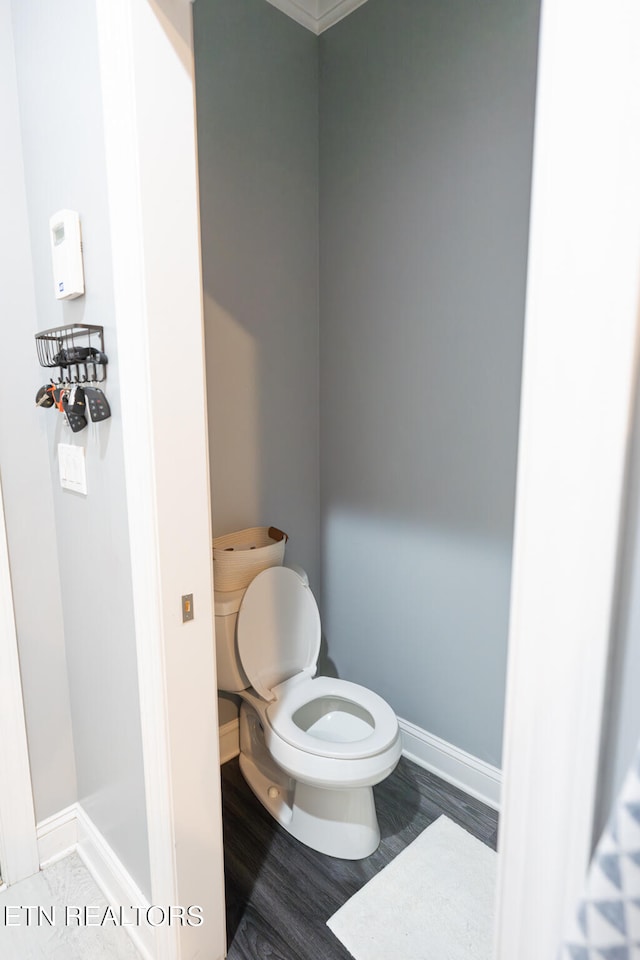 bathroom with toilet and hardwood / wood-style floors