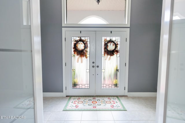 foyer entrance featuring french doors and light tile patterned floors