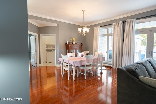 dining area featuring crown molding, a notable chandelier, and wood-type flooring