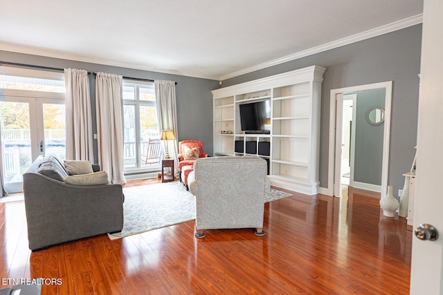 living room with dark wood-type flooring, crown molding, and french doors