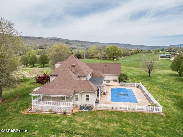 view of pool with central AC and a lawn