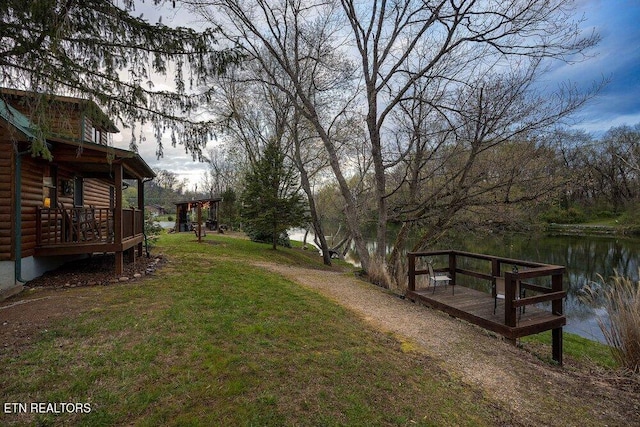 view of yard featuring a deck with water view