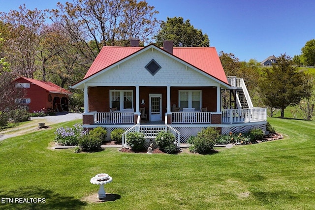 bungalow with covered porch and a front lawn