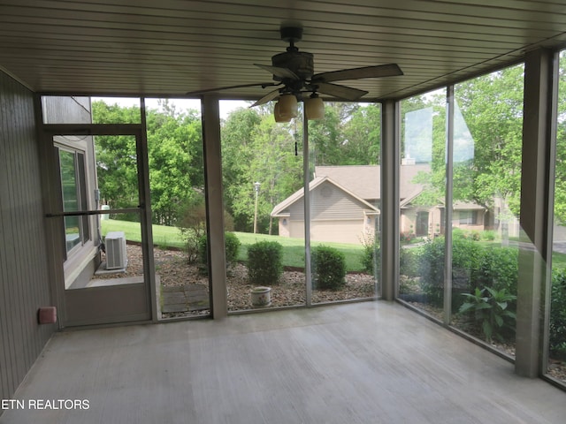 unfurnished sunroom with ceiling fan