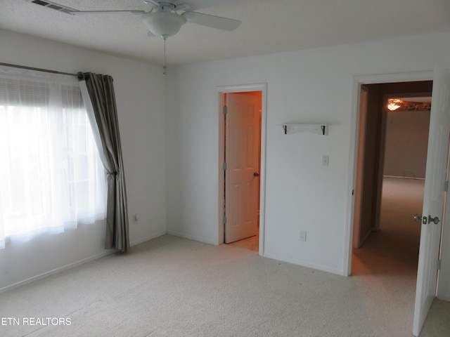 unfurnished bedroom with carpet, visible vents, and baseboards