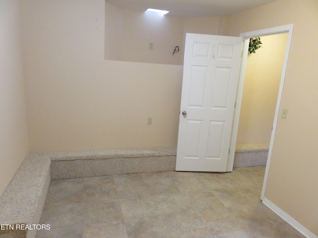 spare room with baseboards