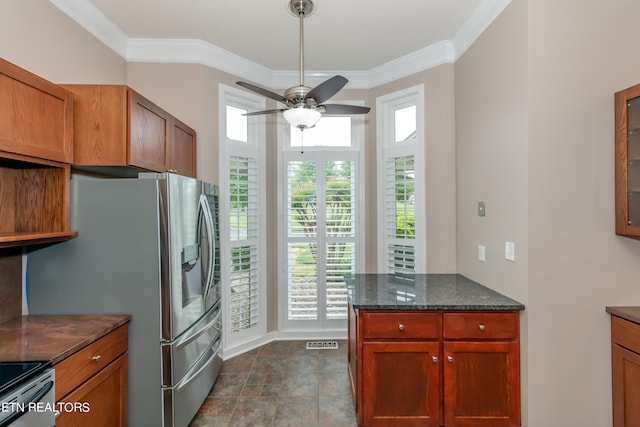 kitchen featuring visible vents, dark stone counters, electric stove, and ornamental molding