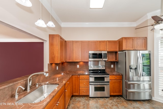 kitchen with decorative backsplash, appliances with stainless steel finishes, brown cabinets, ornamental molding, and a sink