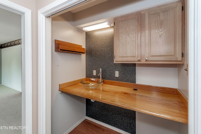 kitchen with light brown cabinets and a sink