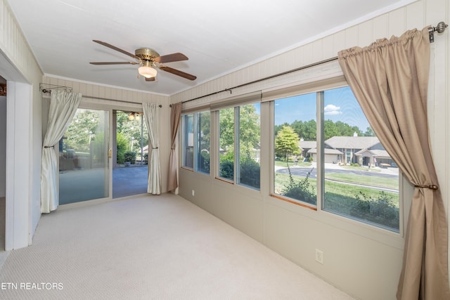 spare room featuring a ceiling fan, ornamental molding, and carpet floors