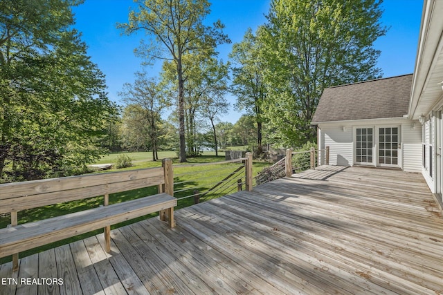 wooden deck featuring a yard