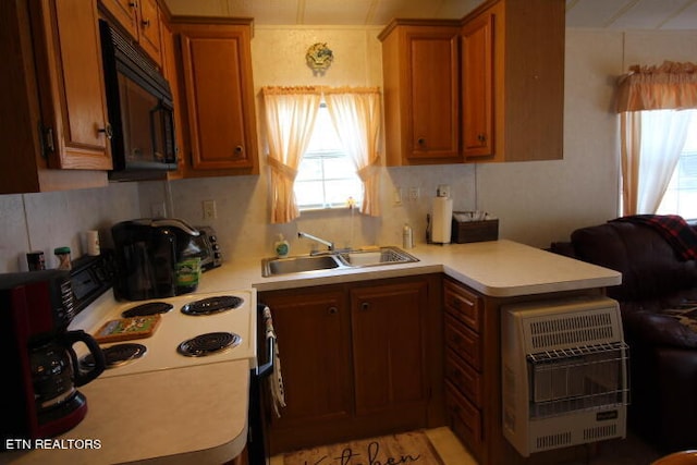 kitchen featuring heating unit and sink