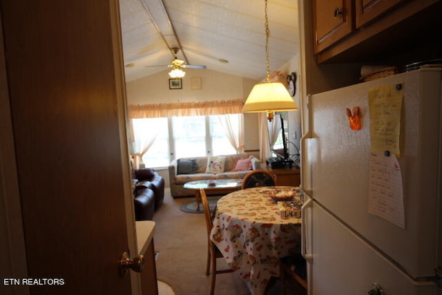 kitchen featuring ceiling fan, white refrigerator, lofted ceiling, and light carpet