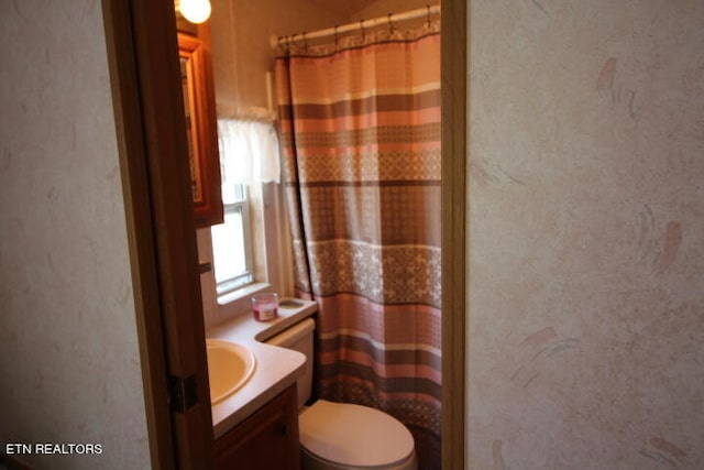 bathroom featuring vanity and toilet