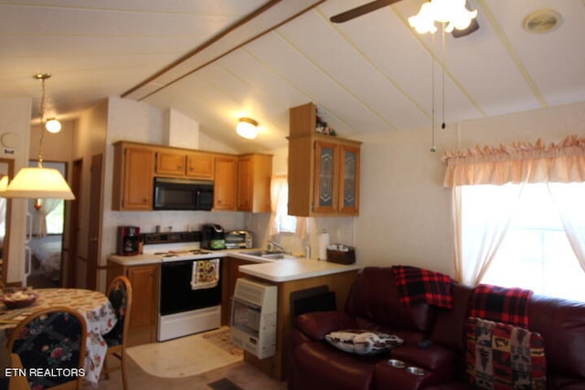 kitchen featuring pendant lighting, lofted ceiling, white stove, ceiling fan, and a healthy amount of sunlight