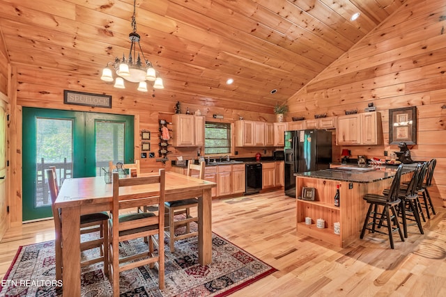 dining area featuring light hardwood / wood-style floors, plenty of natural light, and wooden ceiling