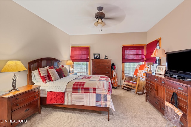 bedroom with multiple windows, carpet, and ceiling fan