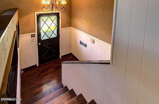 interior space featuring wood-type flooring and a notable chandelier