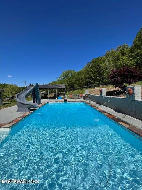 view of swimming pool featuring a water slide