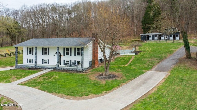 raised ranch with a front lawn