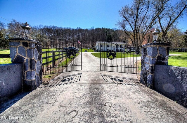 view of gate with a yard