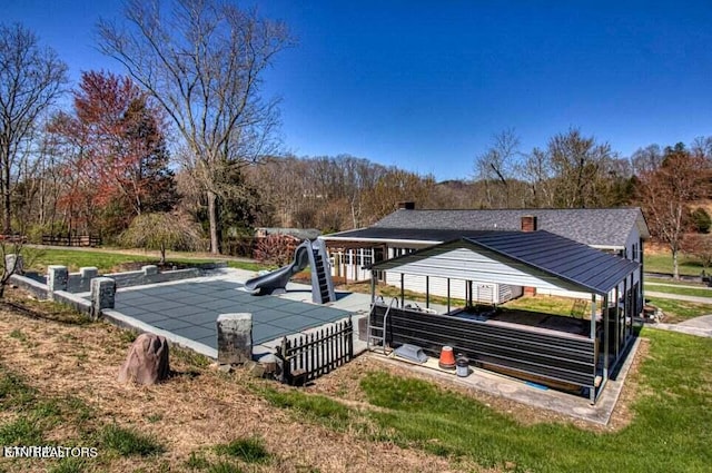 exterior space with a playground and a lawn