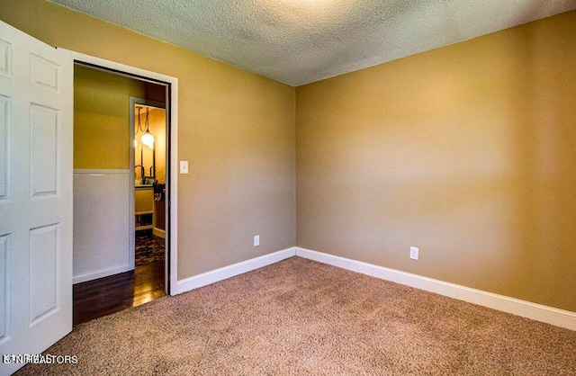 unfurnished bedroom featuring carpet floors and a textured ceiling