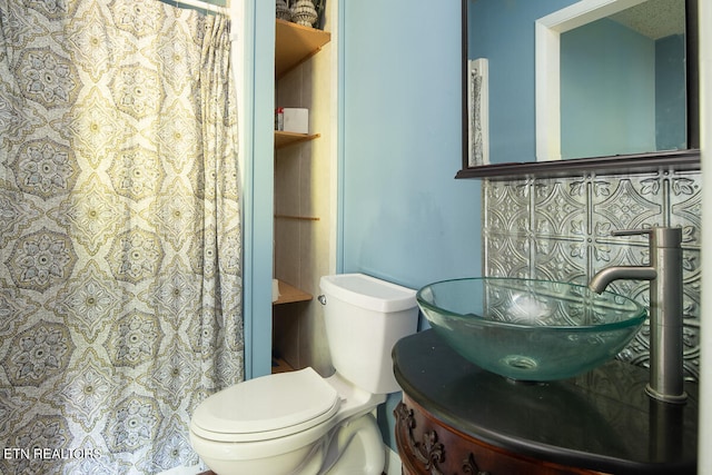 bathroom with toilet and large vanity