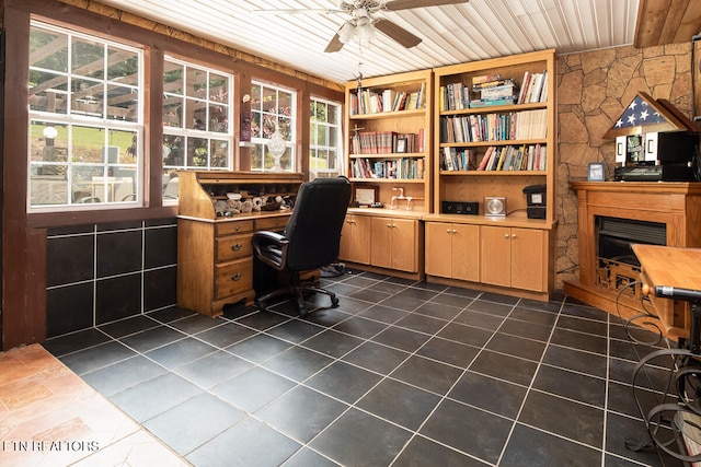 office area featuring dark tile flooring, ceiling fan, and wood ceiling