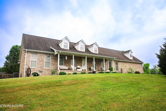 new england style home with central AC unit and a front yard