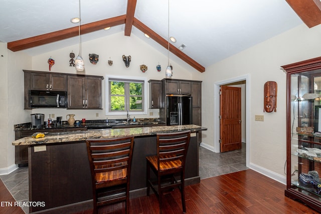 kitchen featuring dark hardwood / wood-style floors, beamed ceiling, decorative light fixtures, and black appliances