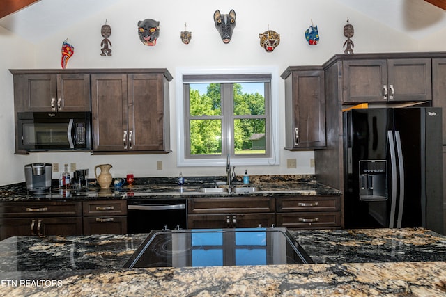 kitchen featuring dark brown cabinets, dark stone counters, sink, and black appliances