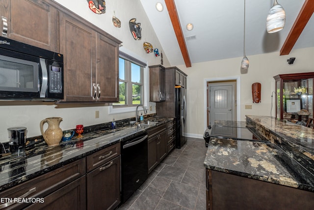 kitchen featuring dark tile floors, vaulted ceiling with beams, sink, dark stone counters, and black appliances