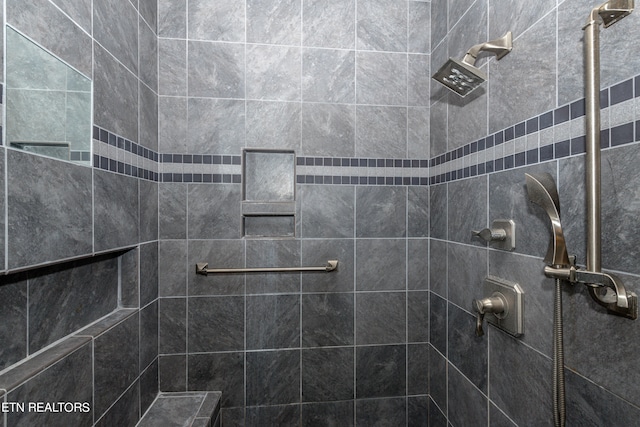 bathroom with tiled shower