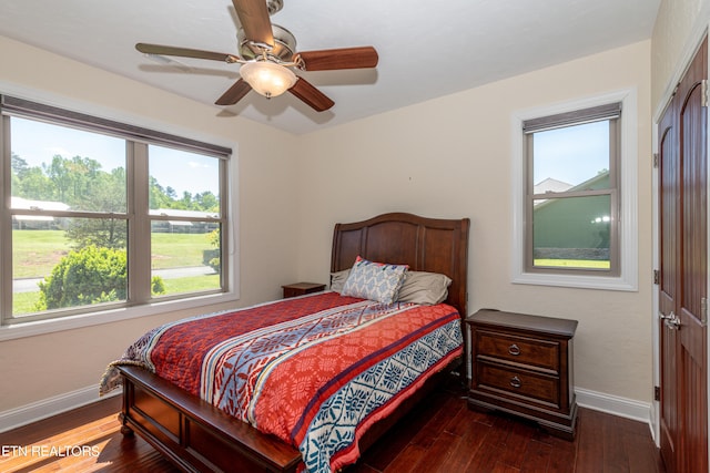 bedroom with ceiling fan and dark wood-type flooring