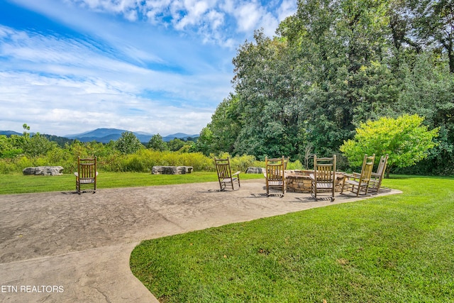 view of home's community featuring a mountain view and a lawn