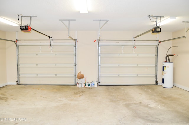 garage with electric water heater and a garage door opener