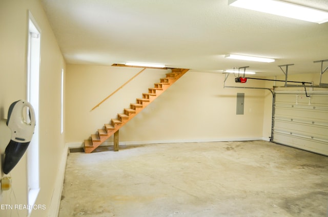 garage featuring electric panel and a garage door opener