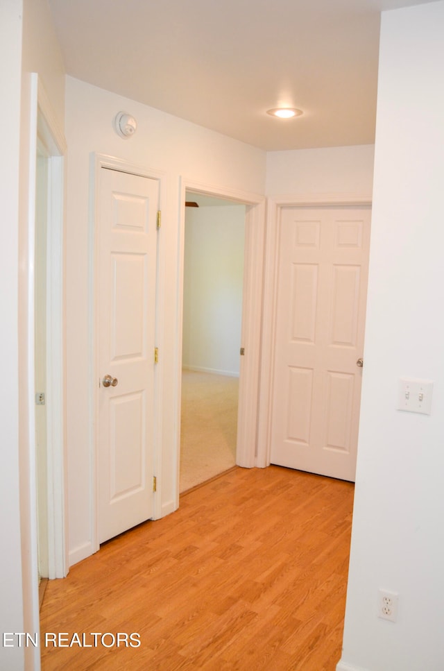 hallway with light hardwood / wood-style flooring