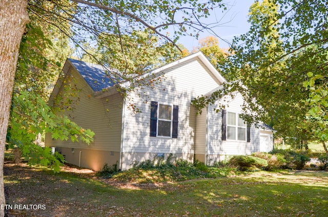 view of side of home featuring a yard