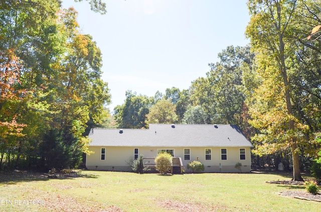 rear view of property with a yard