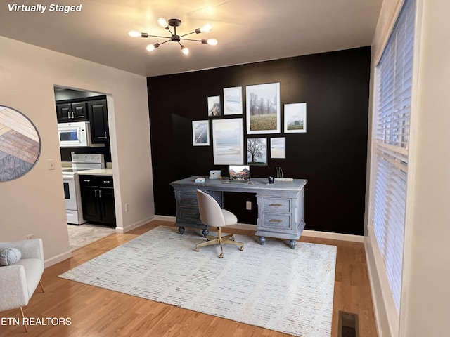 office with a notable chandelier and light hardwood / wood-style floors