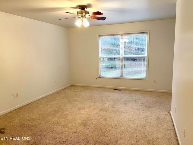 carpeted empty room with ceiling fan