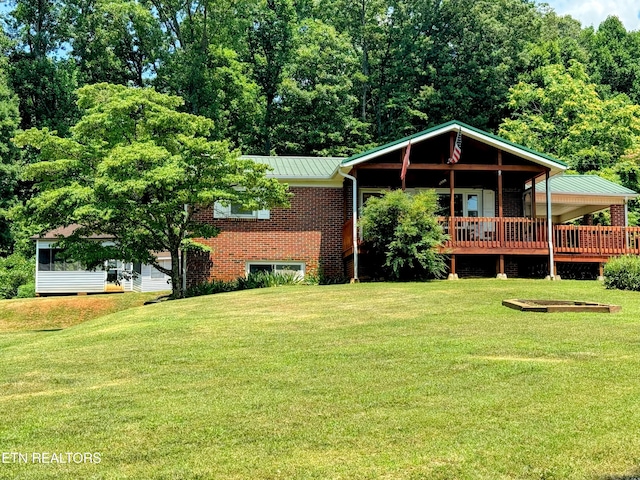 view of front facade with a front lawn and a wooden deck