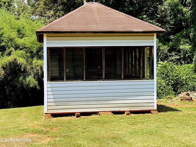 view of property exterior with a lawn