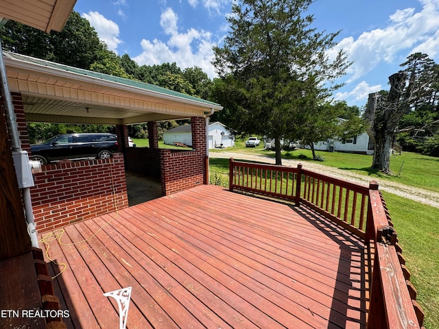 wooden terrace with a lawn