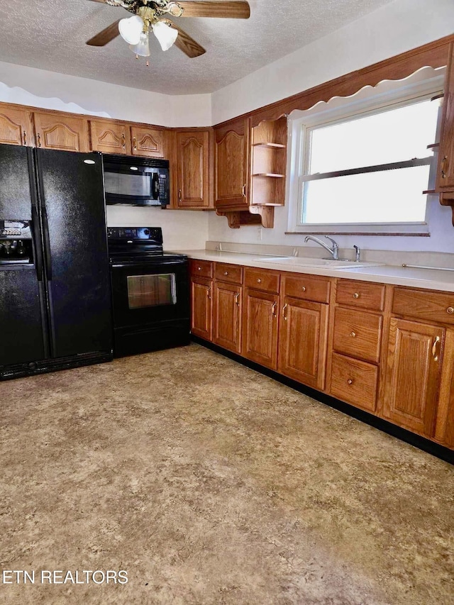 kitchen with ceiling fan, sink, a textured ceiling, and black appliances