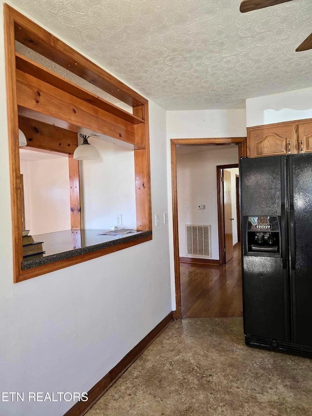 kitchen featuring black refrigerator with ice dispenser, a textured ceiling, and ceiling fan